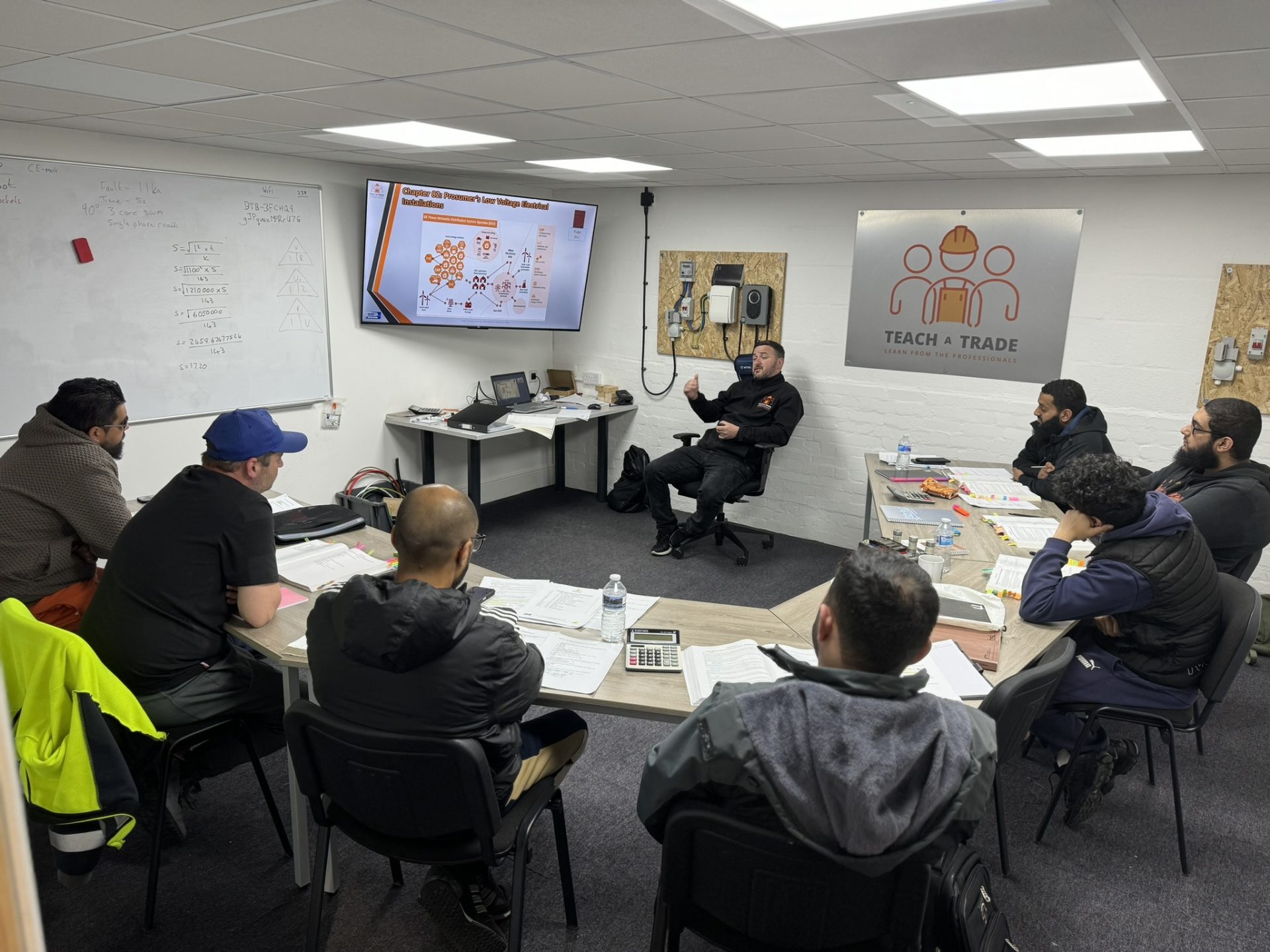 an image of a meeting all of our governance had to showcase the next few months, at Teach A Trade.